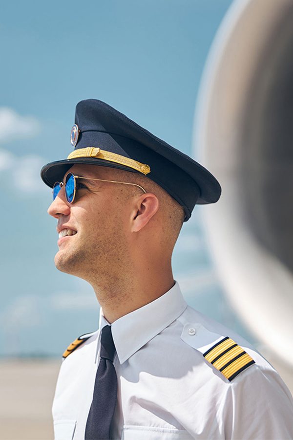 cheerful-pilot-in-2sunglasses-standing-outdoors-in-BX8GZXEaa